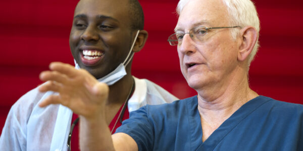 Junior Osinde, left, talks with Dr. Stephen Crane during Operation Lone Star in Mission, Texas, in August 2014.