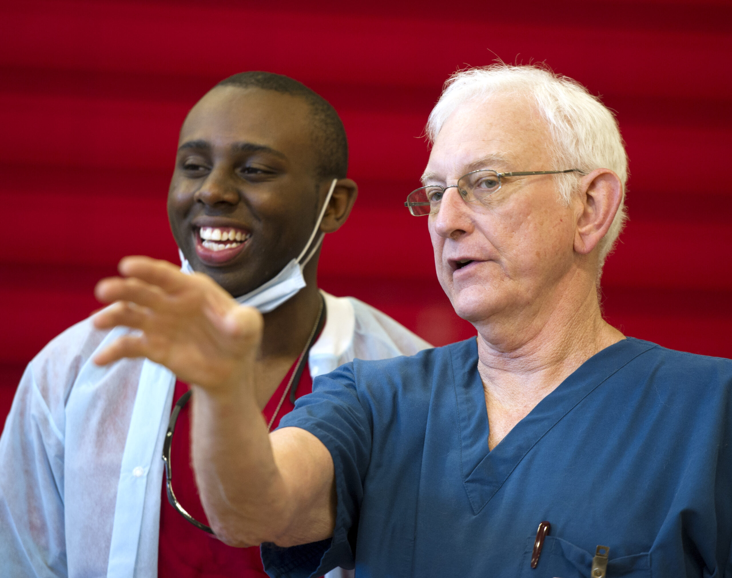 Junior Osinde, left, talks with Dr. Stephen Crane during Operation Lone Star in Mission, Texas, in August 2014.