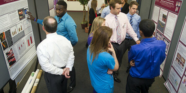 Students and residents share their posters with faculty and peers during the 2014 TAMBCD Research Scholars Day.