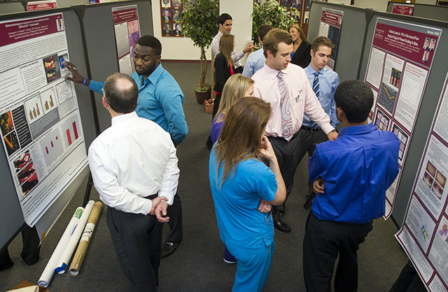 Students and residents share their posters with faculty and peers during the 2014 TAMBCD Research Scholars Day.