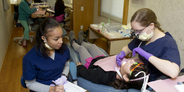 Students treat patients at Give Kids a Smile.