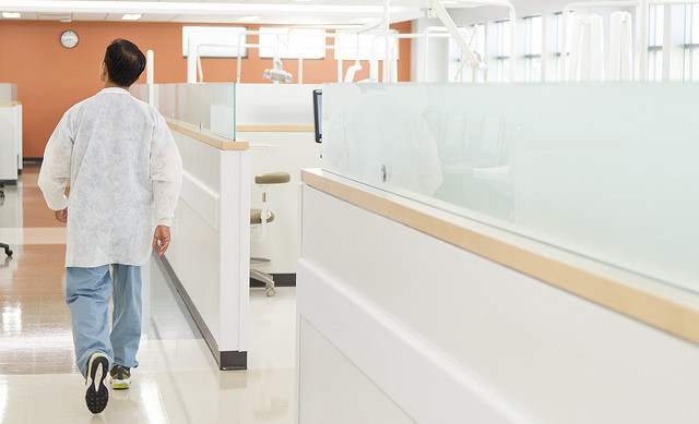 Dr. Don Le, Class of 1998, walks through the Urgent Care Clinic at the University of Texas School of Dentistry at Houston