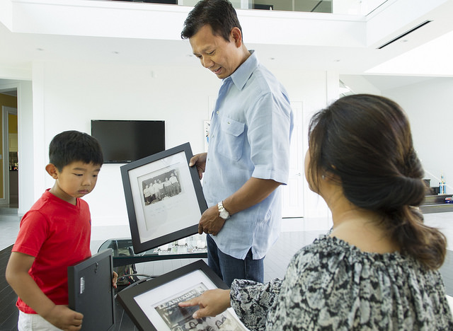 Le shares childhood school photos with his son, Austin and wife, Cindy Le.