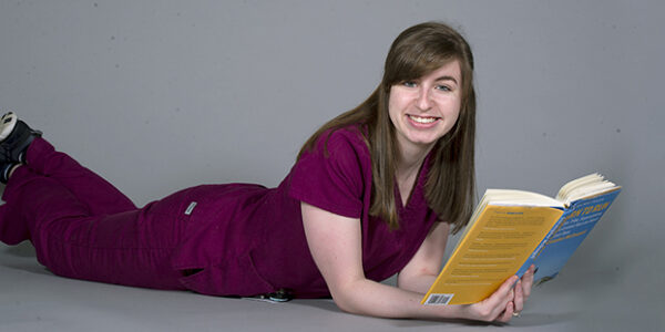 First-year dental hygiene student Briana Bonney with the book "Born to Run"