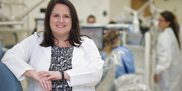 Laurie Inglis, dental hygiene alumna, Class of 2002, in one of the TAMBCD dental clinics