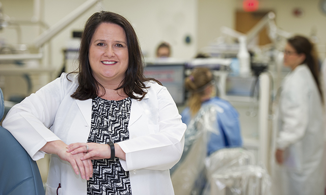 Laurie Inglis, dental hygiene alumna, Class of 2002, in one of the TAMBCD dental clinics