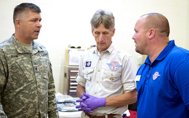 Brig. Gen. Sean Ryan converses with Ronnie Martin of Remote Area Medical, center