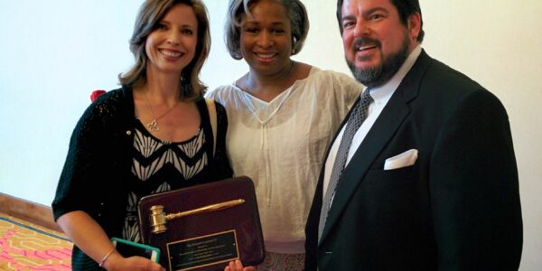 Alumni past-president Dr. Celeste Latham passes the gavel to new president Dr. Lee Kavanagh