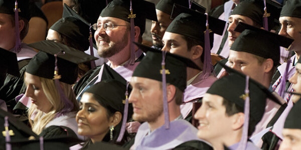 Graduates sit in their seats during commencement exercises on May 27 at the Morton H. Meyerson Symphony Center in Dallas