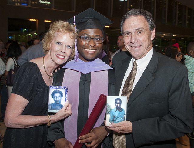 With foster parents Sandy and Deetz Shepherd, holding mementos of Kachepa's birth parents