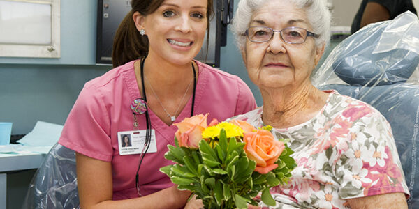 Third-year dental student Katie Freeman with patient Martha Seeber in the clinic