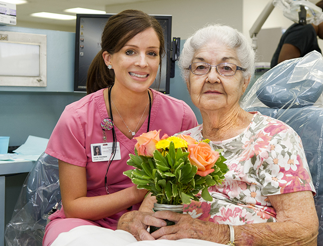 Third-year dental student Katie Freeman with patient Martha Seeber in the clinic