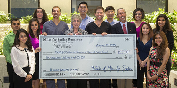 Organizers of the 2015 Miles for Smiles present a check to TAMBCD administrators