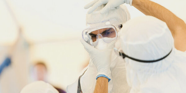 A man dresses in personall protective equipment