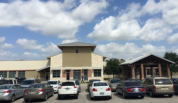 Cars fill the parking lot during a typical weekday at the Bastrop Community Health Center. 