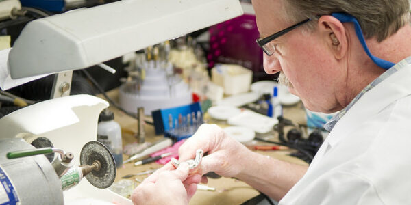 Steve Ruff works in the lab at the college's Center for Maxillofacial Prosthodontics