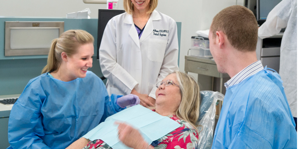 Lisa Mallonee and students with a patient in the clinic.