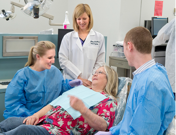 Lisa Mallonee and students with a patient in the clinic.