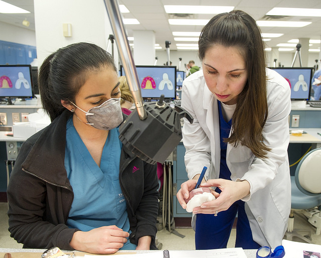 Spence, right, instructs students in the lab.