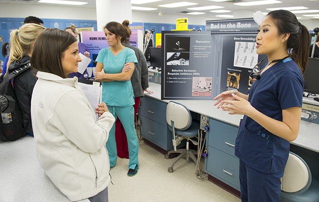 Allison Nguyen and Chloe Hargrove discuss their table clinic presentation.