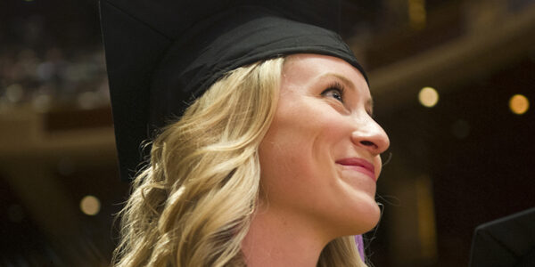 A student smiles during commencement exercises.