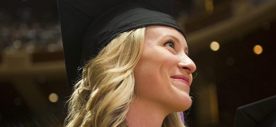 A student smiles during commencement exercises.