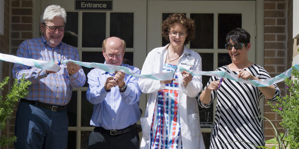 Paul Hoffmann with the dental school, second from left, along with Dr. Barbara Stark Baxter, founder, and Stephanie Bohan, executive director, during the ribbon cutting on June 25.