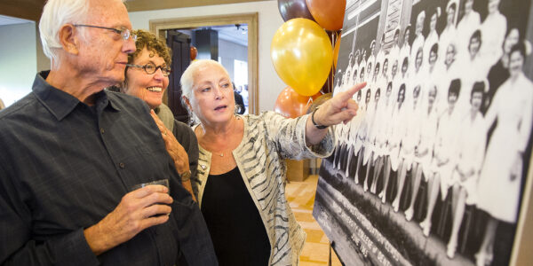 Dental hygiene alumni point out their photos during the 2015 reception at the Omni Hotel Dallas.