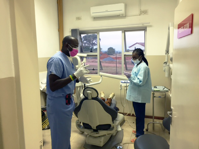 Dr. Jon Clemetson and D4 Abi Adeyeye treat a patient in the dental clinic at Northrise University's NUCare clinic.