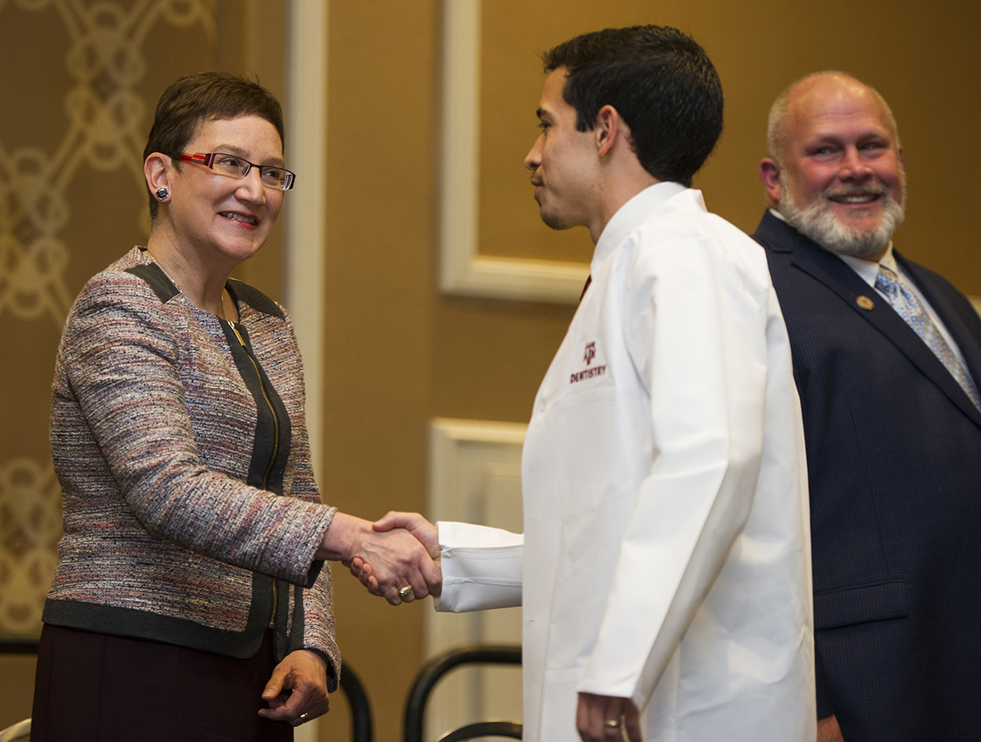 Dr. Carrie Byington greets a dental student during the Texas A&M College of Dentistry White Coat Ceremony on Feb. 3