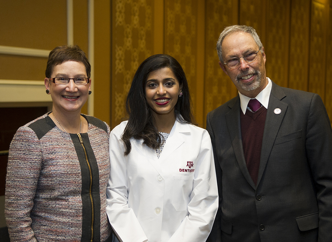 Dr. Carrie Byington and Dr. Lawrence Wolinsky pose for a photo with a student during the 2017 Texas A&M College of Dentistry White Coat Ceremony