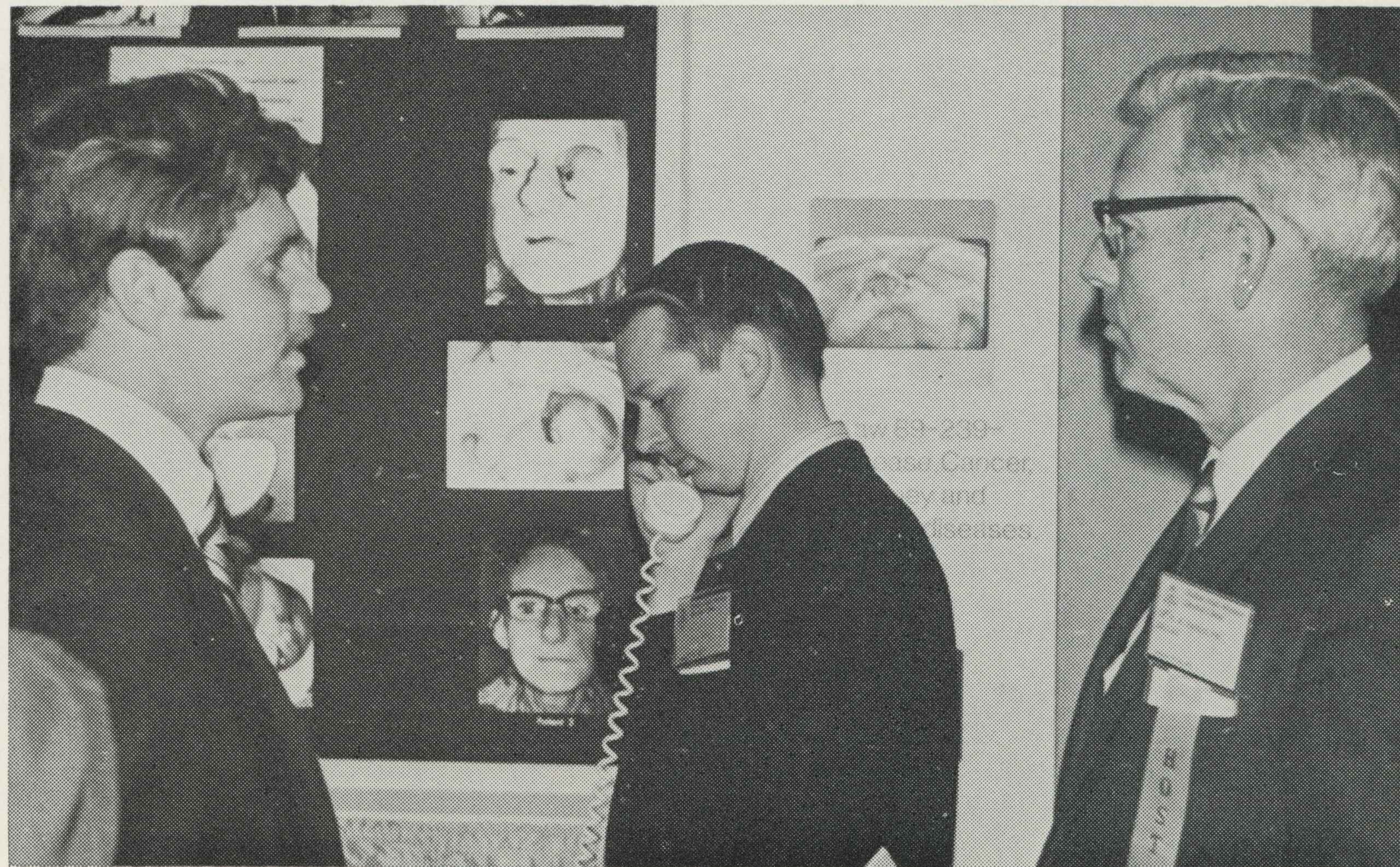 Dr. Roy Rinkle (left) and Dr. Kenneth Randolph (right) at the maxillofacial prosthetic center's exhibit during the Dallas Mid-Winter Clinic in 1971. Dr. Mack Charles Hughes (center), then a senior dental student, listens to one of the exhibit's tape recordings.