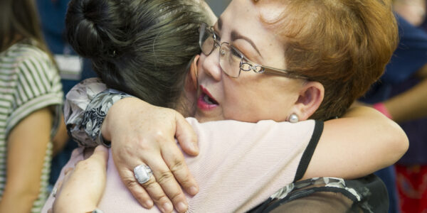 Dr. Loulou Moore receives a hug during her retirement reception