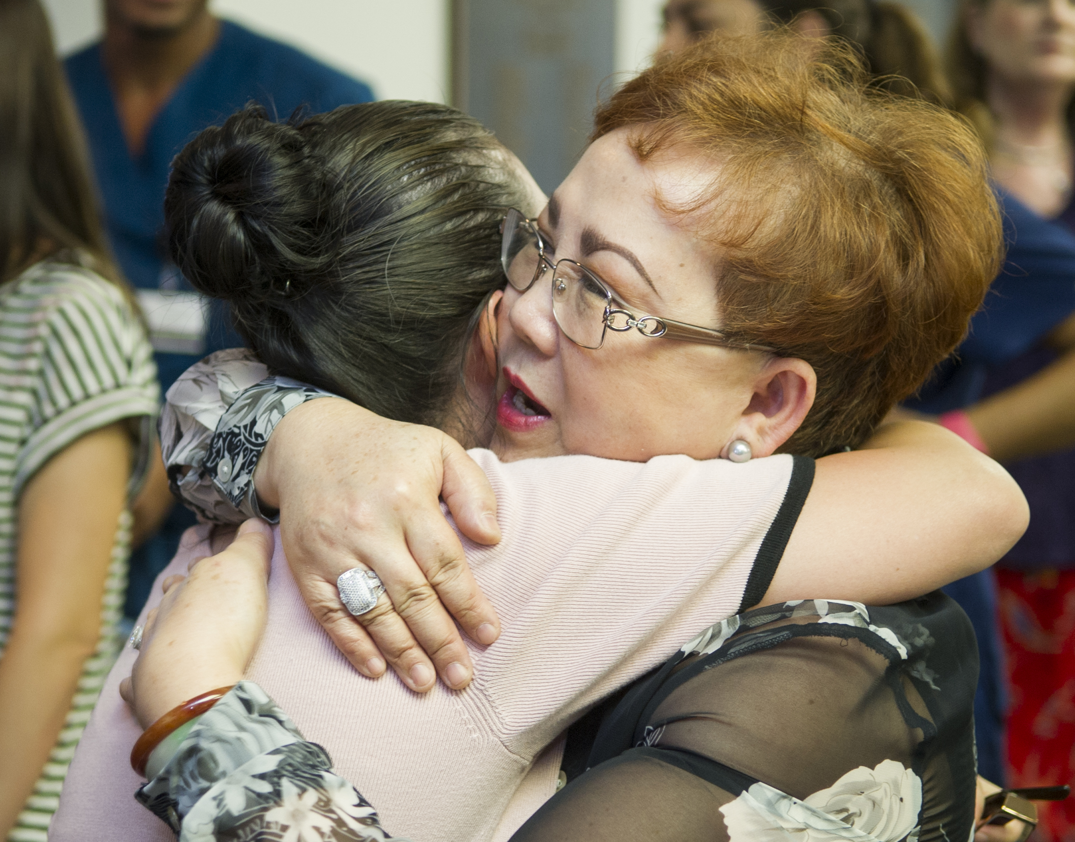 Dr. Loulou Moore receives a hug during her retirement reception