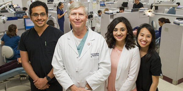 Dr. David Murchison and students at the entrance to the college's Oral Diagnosis Clinic