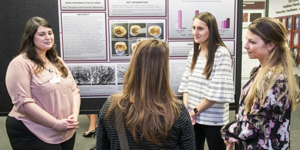 From left: Students Tina Tabrizi, Samantha Barkis and Candace Pope present their poster at Research Scholars Day.