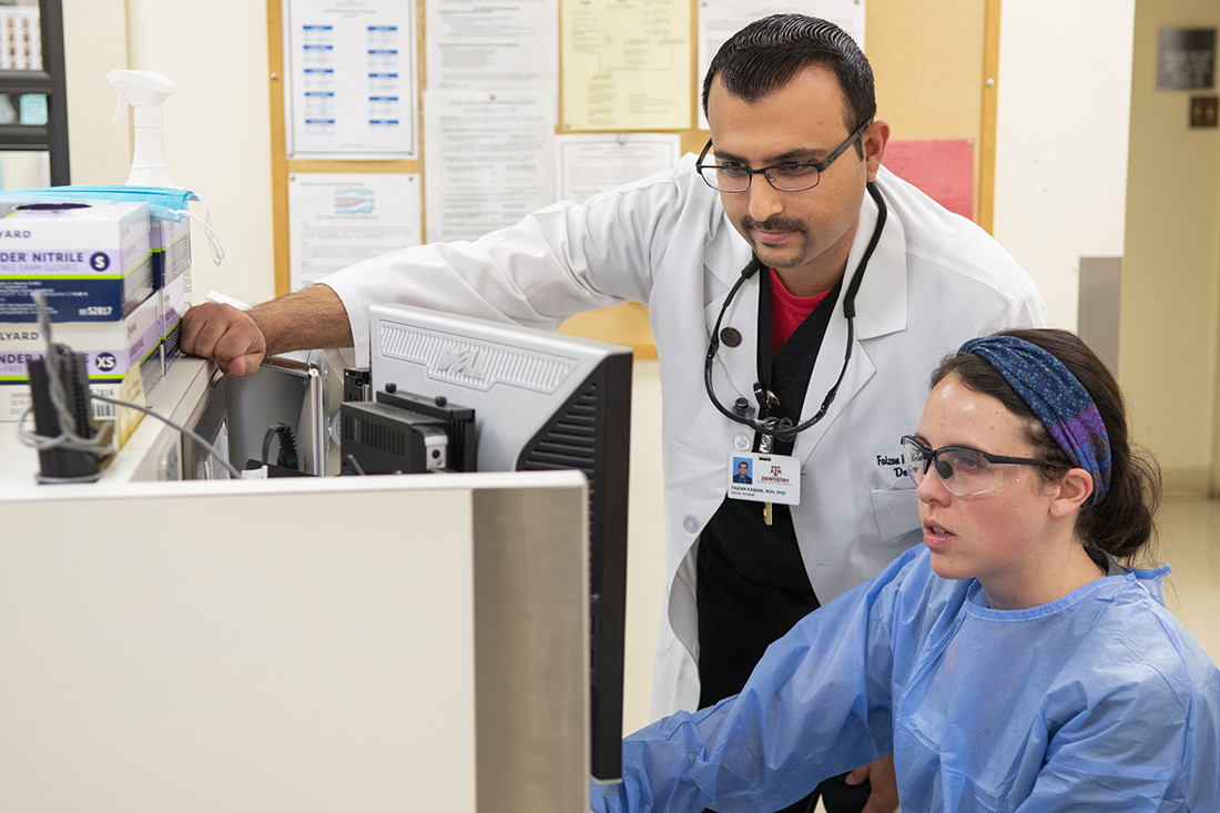 Dr Faizan Kabani with a student in the clinic