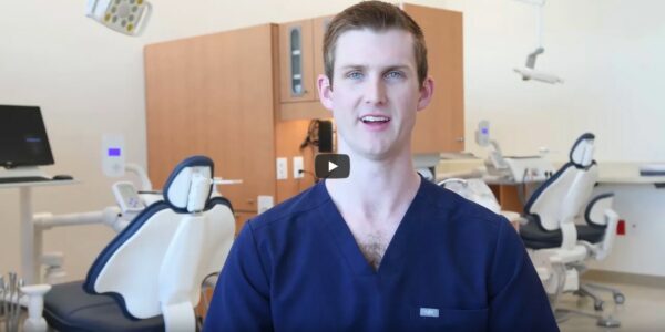 screenshot from video, dentistry student in blue in new clinic building