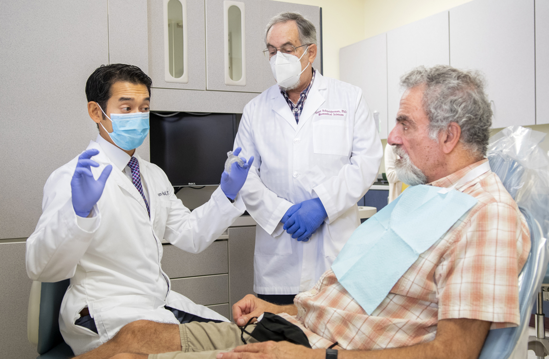 Dr. Jason Hui (left) and Dr. Emet Schneiderman discuss oral appliance options with a sleep study patient.